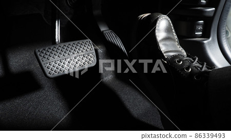 Accelerate and Brake. Foot pressing foot pedal of a car to drive ahead. Accelerator and brake pedal in a car. Driver driving the car by pushing accelerator pedals of the car. inside vehicle automobile 86339493