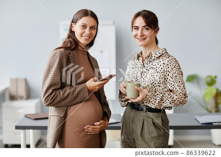 Two colleagues standing at office Two colleagues standing at office 86339622