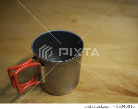 Nice camping gear. Camping equipment is a partner. Let's start with a titanium mug. Copy space. Nice camping gear. Camping equipment is a partner. Let's start with a titanium mug. Copy space. 86340010