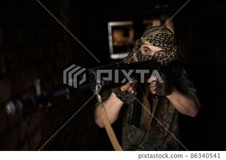 Arab soldier aiming with Kalashnikov AK-47 assault rifle Arab soldier aiming with Kalashnikov AK-47 assault rifle 86340541