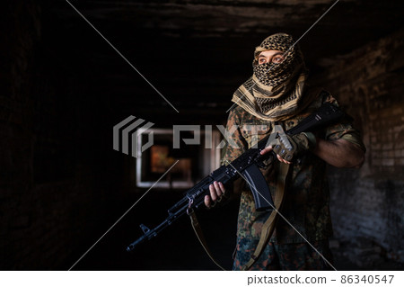 The Arab soldier with the AK-47 Kalashnikov assault rifle 86340547