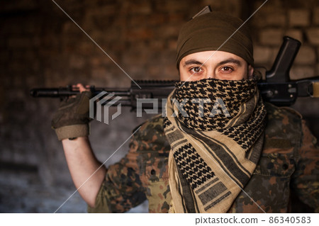 The Arab soldier with the AK-47 Kalashnikov assault rifle The Arab soldier with the AK-47 Kalashnikov assault rifle 86340583