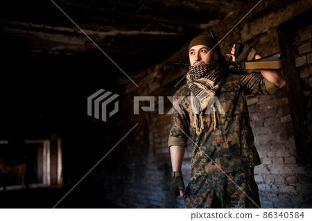 The Arab soldier with the AK-47 Kalashnikov assault rifle 86340584