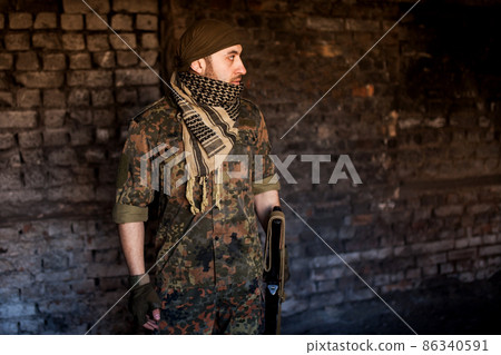 The Arab soldier with the AK-47 Kalashnikov assault rifle The Arab soldier with the AK-47 Kalashnikov assault rifle 86340591