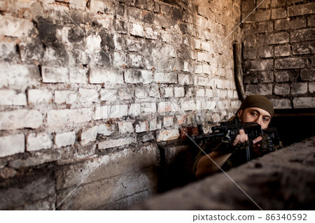 Arab soldier aiming with Kalashnikov AK-47 assault rifle Arab soldier aiming with Kalashnikov AK-47 assault rifle 86340592