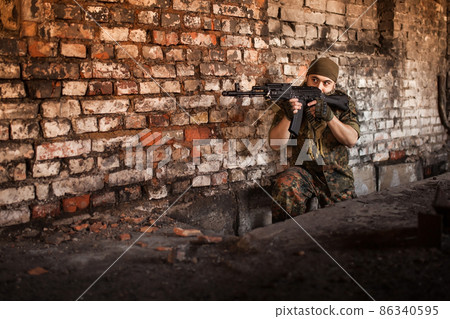 Arab soldier aiming with Kalashnikov AK-47 assault rifle 86340595