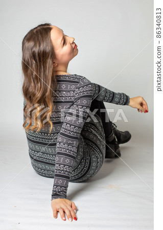 Young woman in warm dress isolated on light grey Young woman in warm dress isolated on light grey 86340813