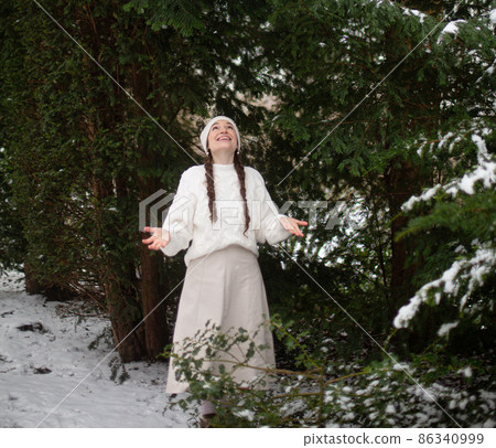 White european young woman in winter forest White european young woman in winter forest 86340999