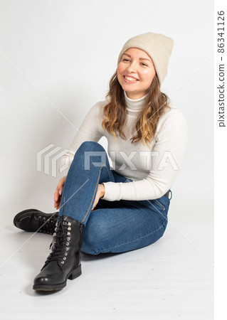 Young woman in warm jumper on white Young woman in warm jumper on white 86341126