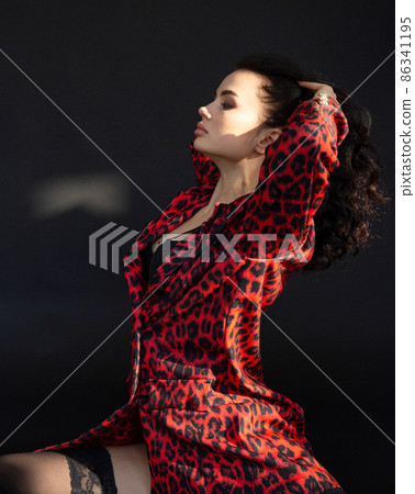 White dark haired woman on dark background White dark haired woman on dark background 86341195