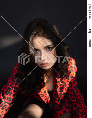 White dark haired woman on dark background White dark haired woman on dark background 86341201