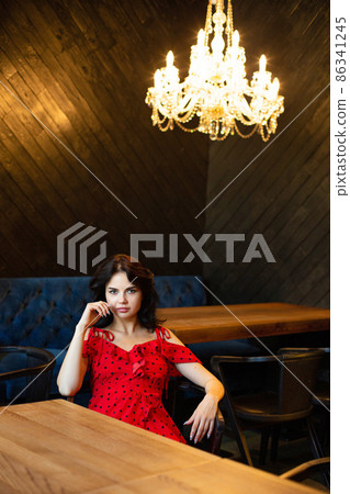 White dark haired woman in dark room White dark haired woman in dark room 86341245