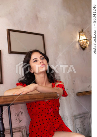 White dark haired woman with pictures behind White dark haired woman with pictures behind 86341246