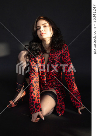 White dark haired woman on dark background White dark haired woman on dark background 86341247