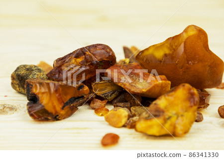 Amber. There are many different transparent pieces of amber, small and large, Ancient wood resin as a mineral for jewelers. The Sunstone Amber. There are many different transparent pieces of amber, small and large, Ancient wood resin as a mineral for jewelers. The Sunstone 86341330