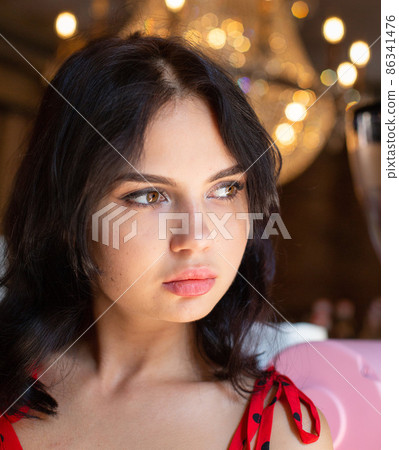 White dark haired woman with lights behind White dark haired woman with lights behind 86341476