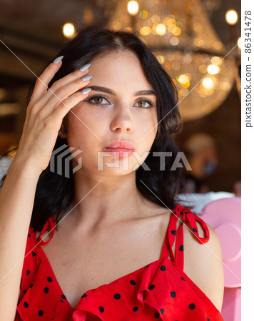 White dark haired woman with lights behind White dark haired woman with lights behind 86341478