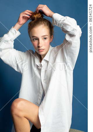 Woman with red hair on blue Woman with red hair on blue 86341724