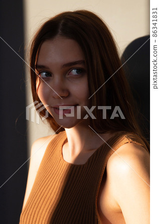 Woman with dark hair on beige 86341831