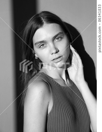 Woman with dark hair on beige 86341833