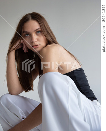 Woman with dark hair on dark grey Woman with dark hair on dark grey 86341835