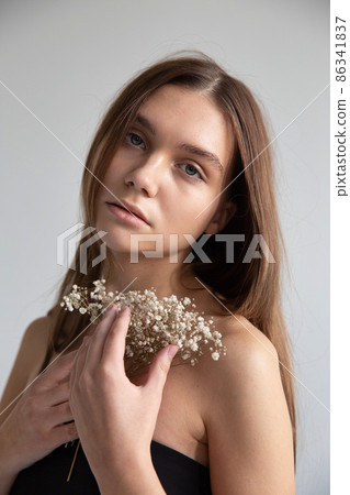 Woman with dark hair on dark grey Woman with dark hair on dark grey 86341837