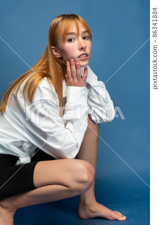 Woman with red hair on blue Woman with red hair on blue 86341884