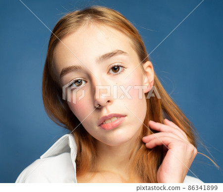 Woman with red hair on blue 86341899