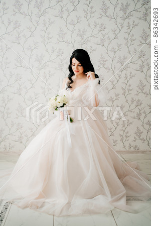 beautiful brunette bride in white dress with bouquet. hair and makeup for bride. 86342693