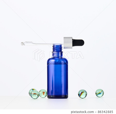 glass bottle with a pipette on a white background. Template for cosmetic liquid products, advertising and promotion 86342885