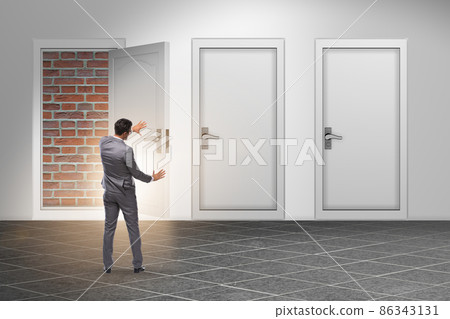 Businessman facing no exit with brick door Businessman facing no exit with brick door 86343131