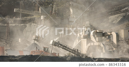 Stone crushing and screening machinery in clouds of dust at gravel quarry Stone crushing and screening machinery in clouds of dust at gravel quarry 86343316