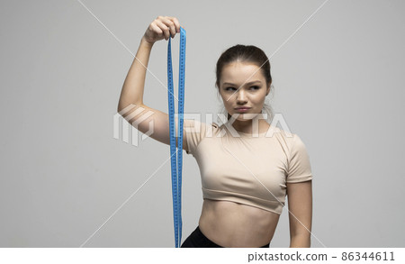 Diet and dieting. Beauty slim female body use tape measure. Woman