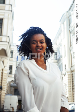 young pretty african girl posing cheerful on city background, lifestyle outdoor people concept young pretty african girl posing cheerful on city background, lifestyle outdoor people concept 86345933