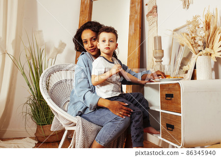 mixed races happy family, african american mother with caucasian son together at home, lifestyle people concept 86345940