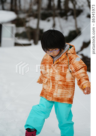 Parents and children playing in the snow 86345973