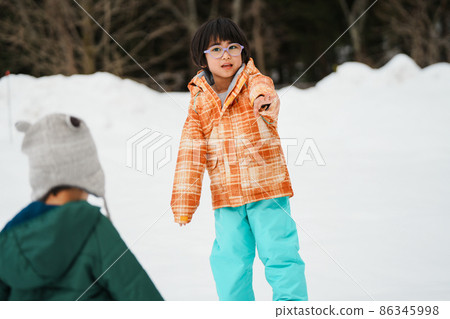 Parents and children playing in the snow Parents and children playing in the snow 86345998