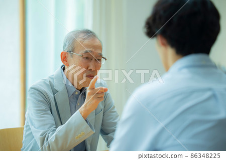 Title Senior and young men talking 86348225