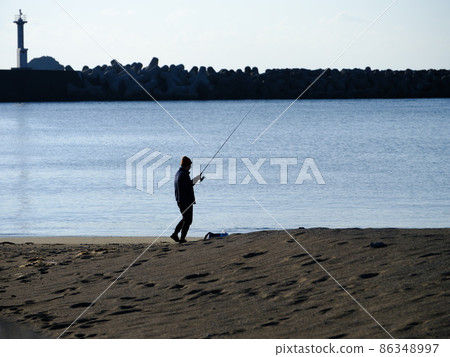 Angler moving around the fishing spot 86348997