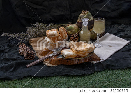 Peel toddy palm and fresh palm juice at front of dark background. 86350715