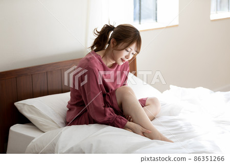 A woman with a foot massage A woman with a foot massage 86351266