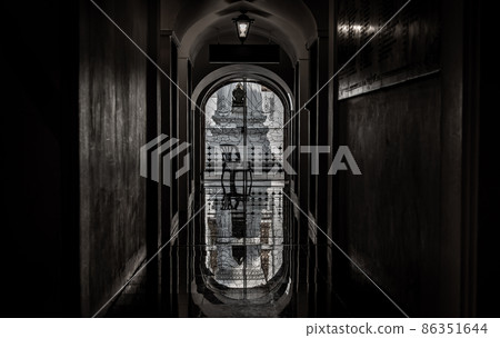 View from Loha Prasat Metal Palace at Ratchanaddaram temple through the gate. Loha Prasat Metal Palace is famous tourist destination in Bangkok, Thailand. 86351644