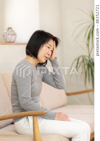 Senior women suffering from headache Senior women suffering from headache 86352721