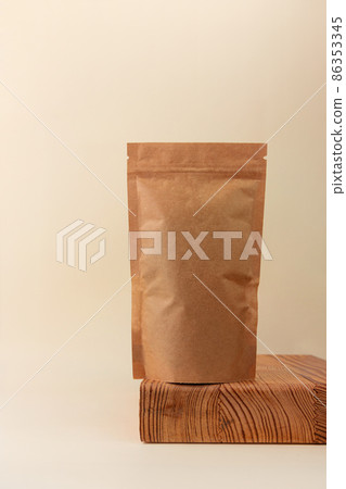Pouch bag mockup wooden podium neutral beige background monochrome. Blank brown kraft paper pack coffee beans tea leaves Pouch bag mockup wooden podium neutral beige background monochrome. Blank brown kraft paper pack coffee beans tea leaves 86353345