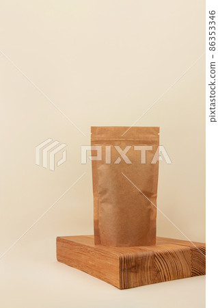 Pouch bag mockup wooden podium neutral beige background monochrome. Blank brown kraft paper pack coffee beans tea leaves Pouch bag mockup wooden podium neutral beige background monochrome. Blank brown kraft paper pack coffee beans tea leaves 86353346