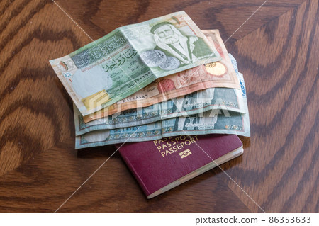Jordanian dinar banknotes and passport. Jordanian dinar banknotes and passport. 86353633