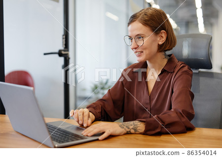 Tattooed Woman using Computer in Office 86354014