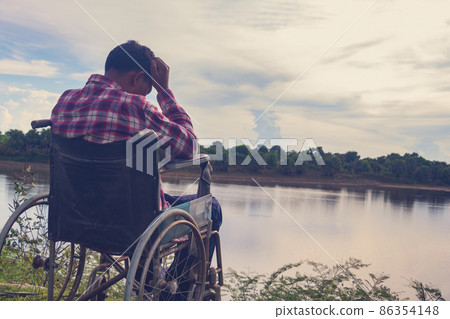 Young disabled man with blue sky background 86354148