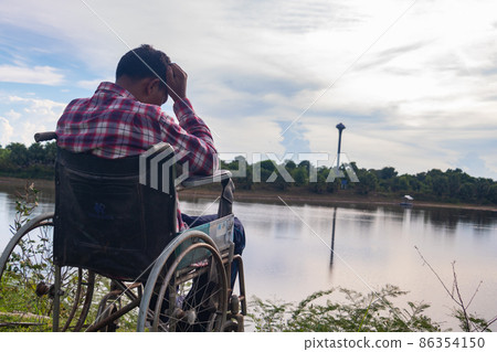 Young disabled man with blue sky background 86354150