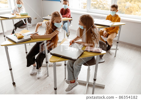Busy school kids with notebooks writing test together Busy school kids with notebooks writing test together 86354182